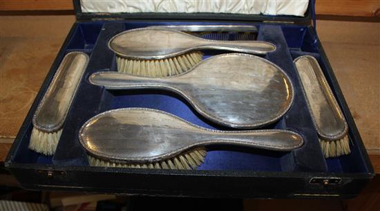 Cased silver backed dressing table set